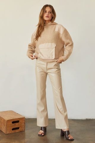 A model wearing a bone vegan leather pants.