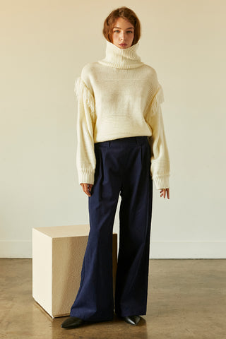A model wearing a navy corduroy pants.