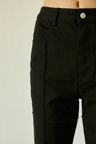 A model wearing a black seam detail denim pants.