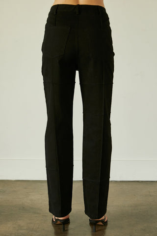 A model wearing a black seam detail denim pants.