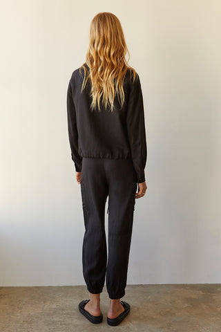 A model wearing a black Tencel blend jogger pants.