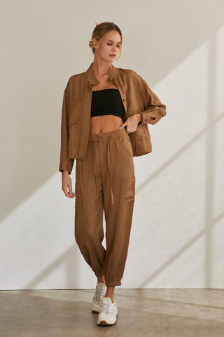 A model wearing a brown Tencel blend jogger pants.