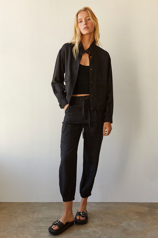 A model wearing a black Tencel blend jogger pants.