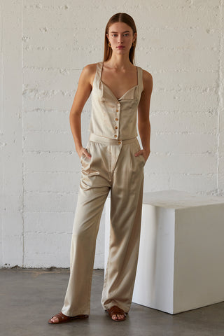 A model wearing a champagne satin pants with matching sleeveless satin top.