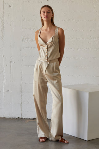 A model wearing a champagne satin pants with matching sleeveless satin top.