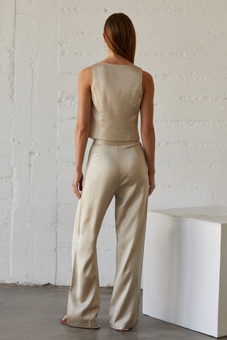 A model wearing a champagne satin pants with matching sleeveless satin top.