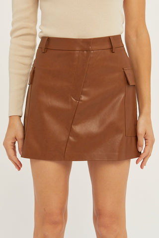 A model wearing a cognac vegan leather utility mini skirt.