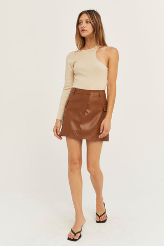 A model wearing a cognac vegan leather utility mini skirt.