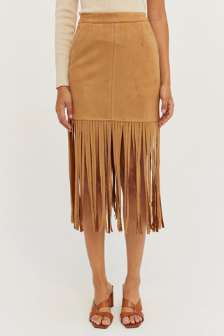 A model wearing a camel fringe suede mini skirt.