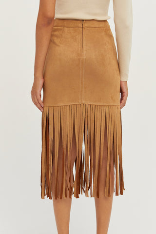 A model wearing a camel fringe suede mini skirt.