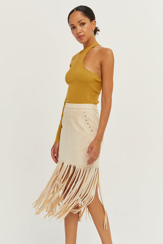 A model wearing a bone fringe suede mini skirt.