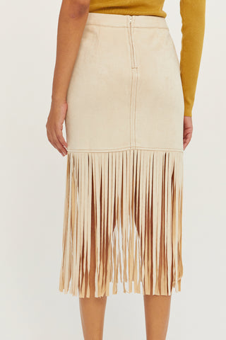 A model wearing a bone fringe suede mini skirt.