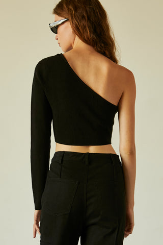 A woman wearing a black one shoulder long sleeve cropped top.