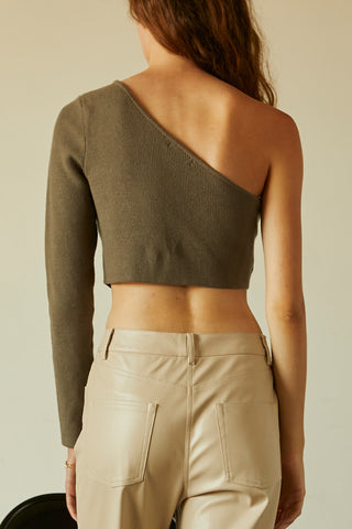 A woman wearing a moss one shoulder long sleeve cropped top.