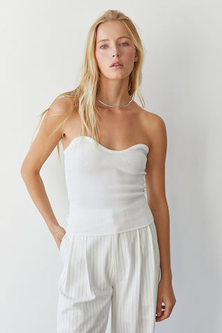A model wearing a white rib corset top.