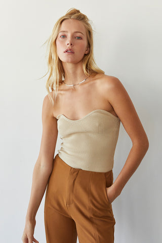 A model wearing a beige rib corset top.