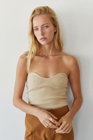 A model wearing a beige rib corset top.
