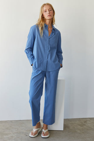 A model wearing a blue linen blend shirt set.