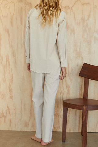 A model wearing an oatmeal linen blend shirt set.