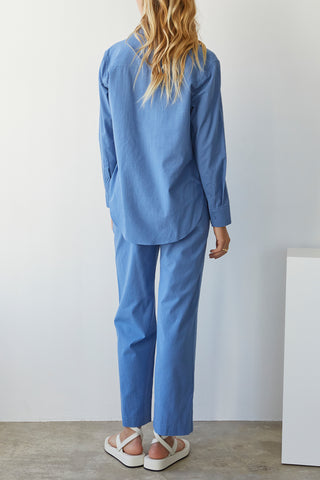 A model wearing a blue linen blend shirt set.