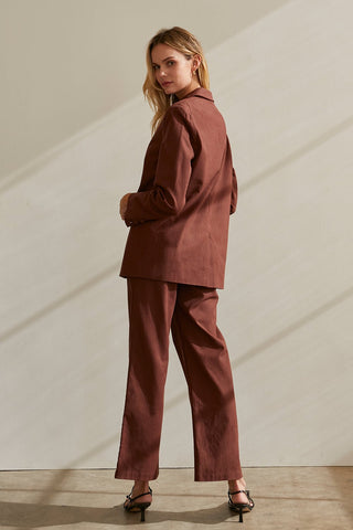 A model wearing a chocolate blazer set.
