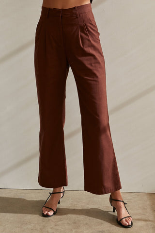 A model wearing a chocolate blazer set.