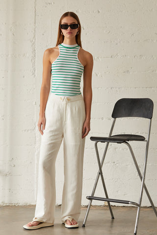 A model wearing a green stripe racer knit top.