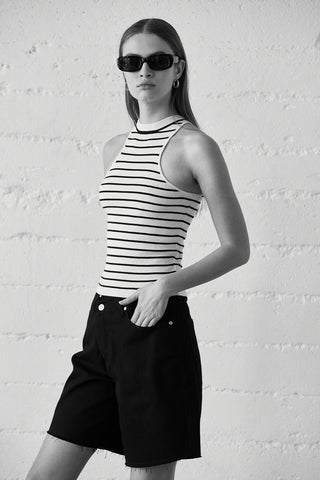 A model wearing a black stripe racer knit top.
