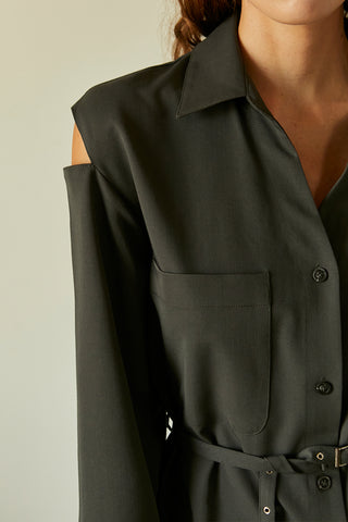 A model wearing a slate cut out sleeve tunic top with micro belt on waist.