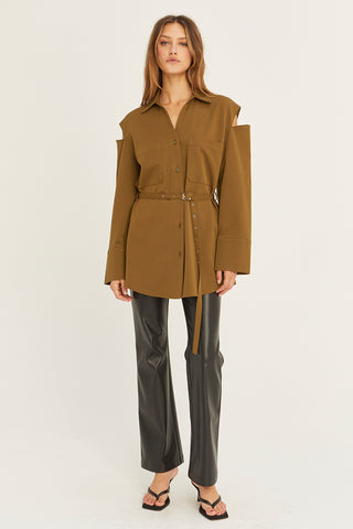 A model wearing a coffee cut out sleeve tunic top with micro belt on waist.