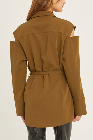 A model wearing a coffee cut out sleeve tunic top with micro belt on waist.