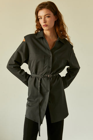 A model wearing a slate cut out sleeve tunic top with micro belt on waist.