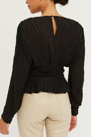 A model wearing a black crinkled blouse.