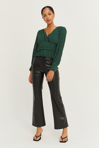 A model wearing a hunter green crinkled blouse.