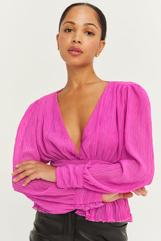 A model wearing a fuchsia crinkled blouse.