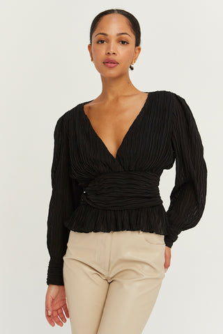A model wearing a black crinkled blouse.