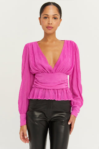 A model wearing a fuchsia crinkled blouse.