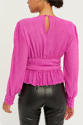 A model wearing a fuchsia crinkled blouse.