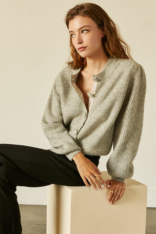 A model wearing a heather grey jacquard trim cardigan.