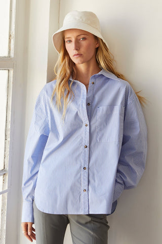 A model wearing a blue pinstripe shirt.