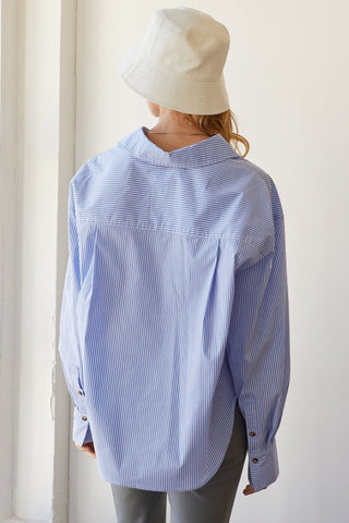 A model wearing a blue pinstripe shirt.