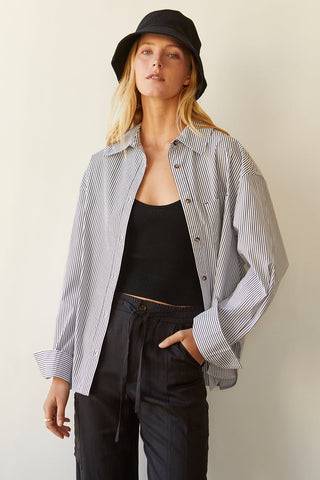 A model wearing a black pinstripe shirt.