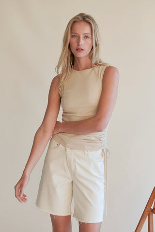 A model wearing an oatmeal ruched top.