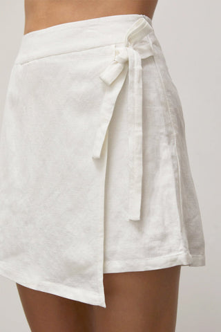 A woman waring an ivory warp skort.