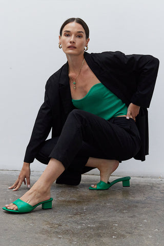 A woman wearing an emerald rib corset top.