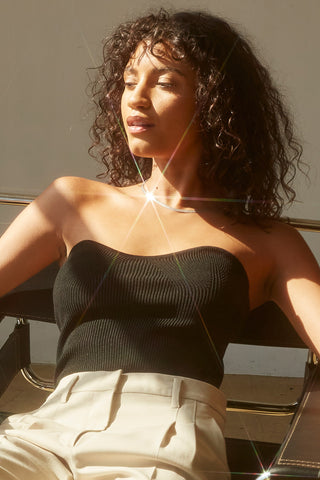 A woman wearing a black rib corset top.