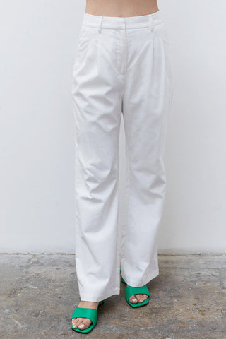 A woman wearing a white pleated babydoll camisole set.