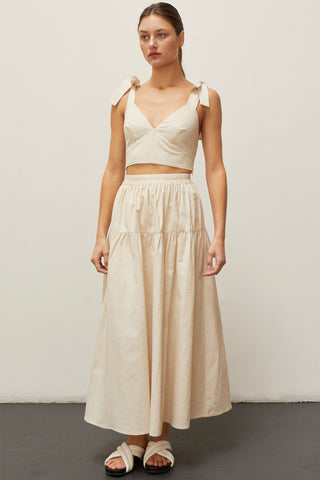 A woman wearing an oatmeal bow tie top two piece set.