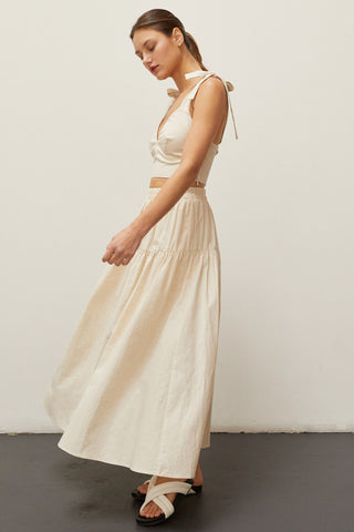 A woman wearing an oatmeal bow tie top two piece set.