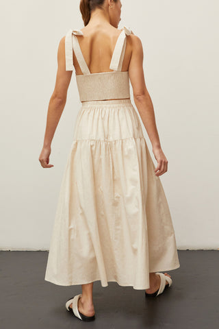 A woman wearing an oatmeal bow tie top two piece set.